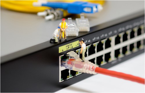 miniature technicians working on a network switch