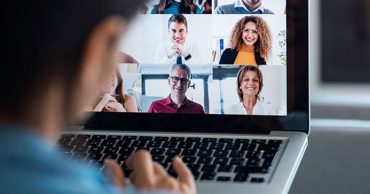 Woman in a virtual meeting on laptop.