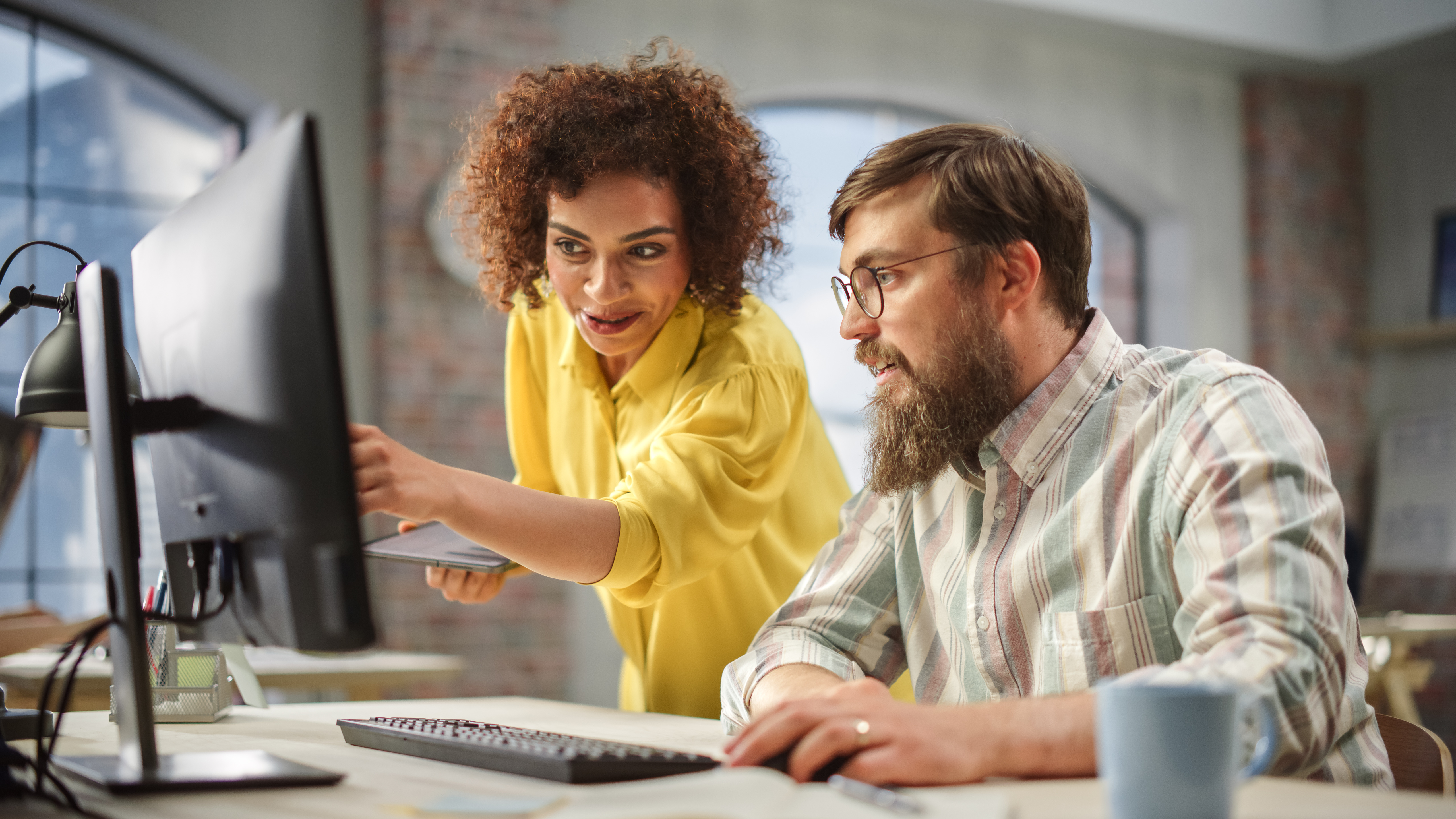 Two people working at computer